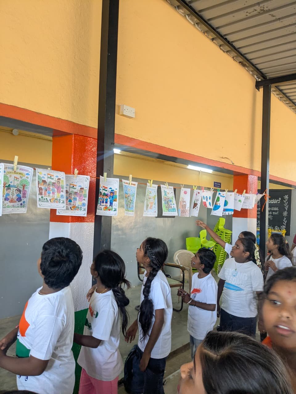 Students participating in artwork activity during Independence Day programme at Shanthipura