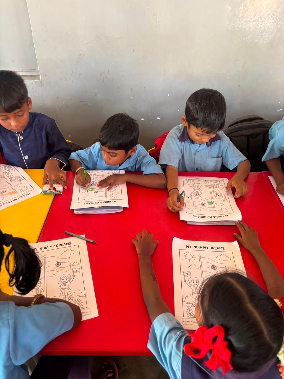 Students participating in artwork activity during Independence Day programme at Shanthipura