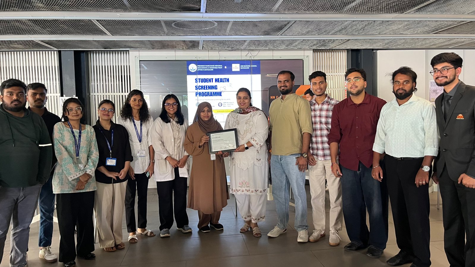 Recognition portrait with the certificate during the ISBR campus health camp